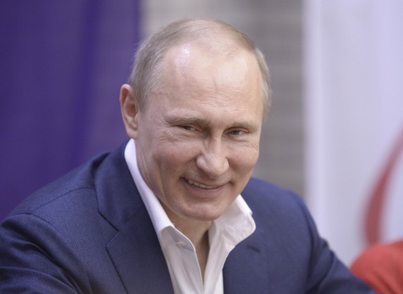 Russian President Vladimir Putin smiles as he celebrates International Women's Day in Sochi