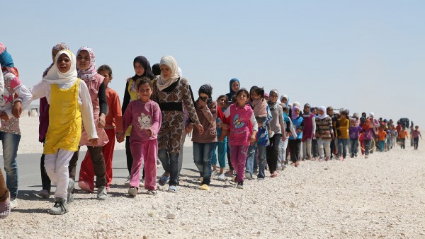  Syrian children march in the refugee camp in Jordan. The number of Children in this camp exceeds 60% of the total number of refugees hence the name "Children's camp". Some of them lost their relatives, but others lost their parents.