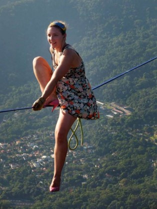 PIC BY REGINALDO GOMES/ CATERS NEWS - (PICTURED: Faith taking a rest during her highline walk in pink heels over Rio) - Heels can be a pain at the best of times, but one woman has taken it to new heights. Faith Dickey, 26, from Austin, Texas, made the hair-raising highline walk during the Highgirls Brazil Festival in a pair of bright pink kitten heels. At 840 metres above sea level daredevil Faith had only a slim cord attaching her to the line in the event she tripped over her feet. The astonishing photos were taken by Reginaldo Gomes, 34, a photographer from Brazil, while he watched Faith cross the Pedra da Gvea one of the countrys most famous highlines in Rio de Janeiro. SEE CATERS COPY.