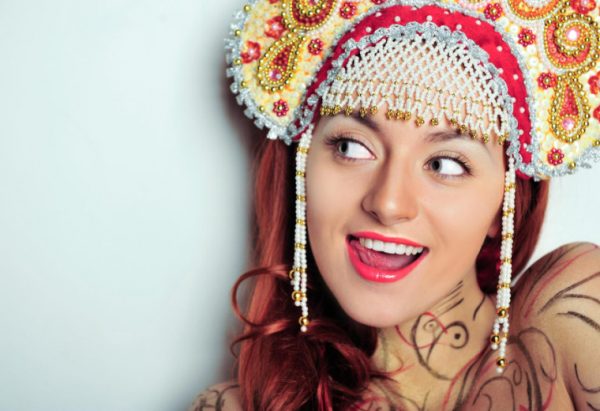 Closeup portrait of young beautiful woman wearing russian traditional hat kokoshnik. Advertisement banner for beauty and fashion industry with copyspace