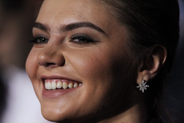 MOSCOW, RUSSIA - NOVEMBER 27: Russian politician and former Olympic Champion, Alina Kabaeva, smiles as Prime Minister Vladimir Putin (not pictured) delivers his speech at the congress of the United Russia Party November, 27, 2011 in Moscow, Russia. Putin accepted the nomination to return to Russia's presidency ahead of the election in March. (Photo by Sasha Mordovets/Getty Images)